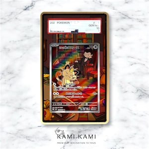 May include: A graded Pok&eacute;mon card featuring a Meowth illustration with Japanese text, encased in a gold-colored frame. The card is graded as a GEM M 10. The background shows a library scene.
