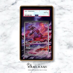 May include: A graded Pokemon trading card featuring a red and purple creature called "Groudon" with a background of a volcano erupting. The card is graded GEM MT 10 by PSA.