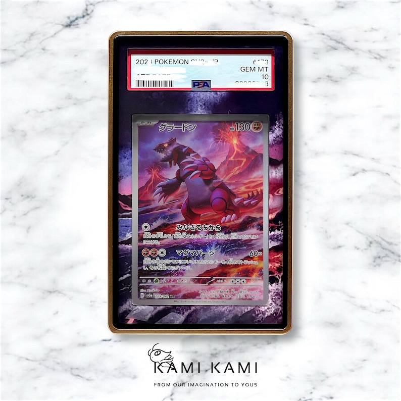 May include: A graded Pokemon trading card featuring a red and purple creature called "Groudon" with a background of a volcano erupting. The card is graded GEM MT 10 by PSA.