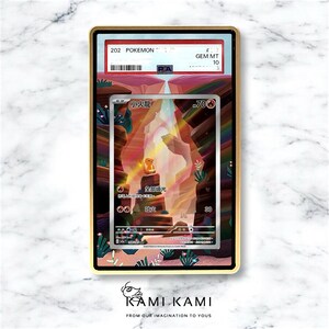 May include: A framed Pok&eacute;mon trading card featuring a colorful illustration of a Charmander in a cave setting. The card is graded and encased in a gold-colored frame. The text "202 Pok&eacute;mon" is visible.