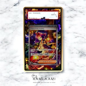 May include: A graded Pok&eacute;mon trading card featuring a colorful illustration of a character with purple hair. The card is encased in a gold-colored frame with the text "202 Pok&eacute;mon" visible. The card is graded GEM MINT 10.