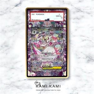 May include: A framed Pok&eacute;mon card featuring a Gardevoir EX illustration with Japanese text. The card is graded GEM MINT 10 and encased in a gold-colored frame. The card's artwork includes pink, white, and purple hues.