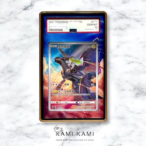 May include: A framed Pok&eacute;mon trading card featuring a black and white illustration of a character riding a dragon-like creature. The card is graded GEM MT 10 and includes Japanese text. The frame is gold-colored.