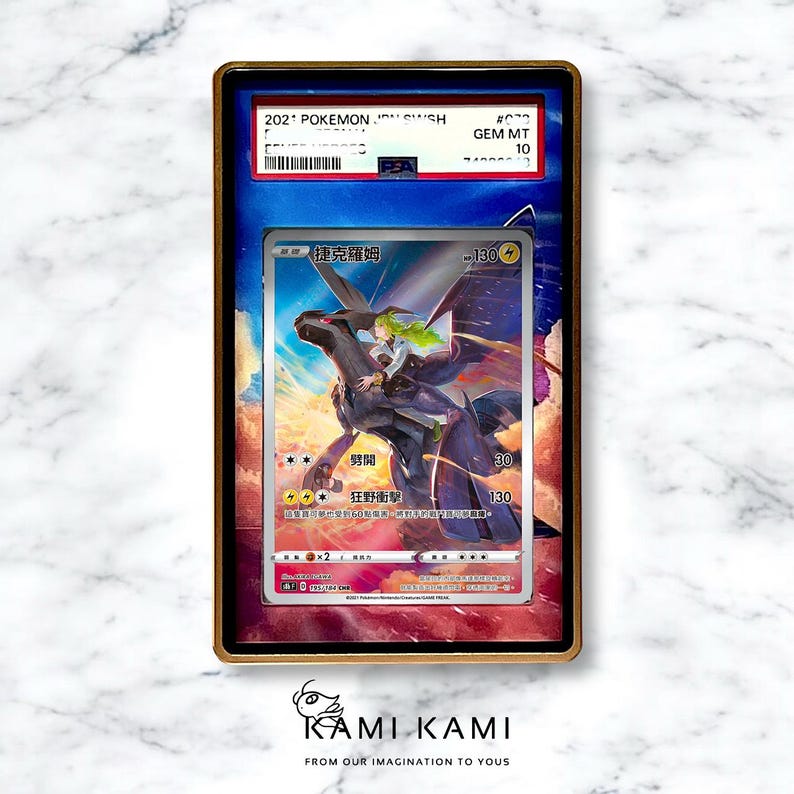 May include: A framed Pok&eacute;mon trading card featuring a black and white illustration of a character riding a dragon-like creature. The card is graded GEM MT 10 and includes Japanese text. The frame is gold-colored.