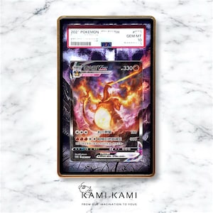 May include: A graded Pok&eacute;mon card featuring Charizard VMAX, with a fiery orange and yellow illustration. The card is encased in a gold-framed holder with the text "GEM MT 10". The card's details include Japanese text and a PSA authentication label.