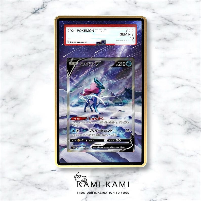 May include: A graded Pok&eacute;mon card featuring Suicune V, encased in a gold-colored frame. The card displays a vibrant illustration of Suicune in a snowy landscape, with Japanese text and a GEM MINT 10 grade.