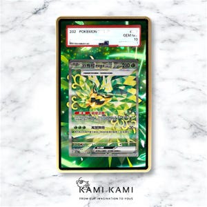 May include: A framed Pok&eacute;mon trading card featuring a green and yellow illustration of a creature. The card is graded and encased in a gold-colored frame. The card has Japanese text and the number 210.