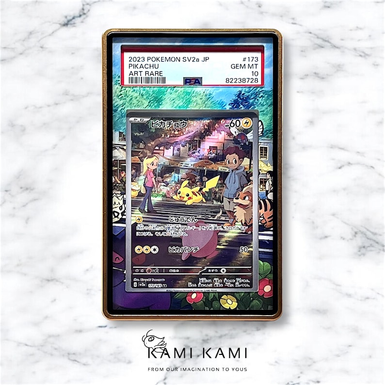 May include: A graded Pokemon trading card featuring Pikachu in an art rare version. The card is encased in a protective plastic case with a PSA label indicating a Gem Mint 10 rating. The card features a colorful illustration of Pikachu with other Pokemon characters in a city setting. The card is from the 2023 Pokemon SV2a JP set.