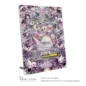 以下が含まれることがあります： 紫と白の花柄模様の透明アクリルディスプレイフレーム。白いドレスを着たキャラクターが描かれた日本のトレーディングカードを収納。フレームにはスタンドが付いています。