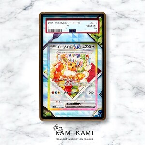 May include: A Japanese Pokemon trading card featuring Eevee, a light brown fox-like Pokemon with a rainbow-coloured background. The card is graded GEM MT 10. The card text reads "Eevee 200*" and "Rainbow DNA".