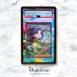 May include: A graded Pok&eacute;mon card featuring "Parasol Lady" artwork. The card is encased in a protective holder with text indicating it's a Special Art Rare from 2023. The card's artwork depicts a woman under a rainbow-colored umbrella.