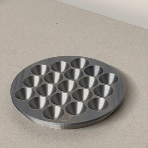May include: A gray plastic tray with 24 round depressions, perfect for holding small items like beads or buttons.