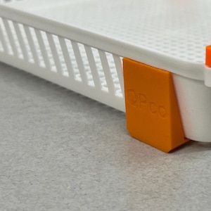 May include: A white food dehydrator with an orange plastic piece that says "OPCO" on it.