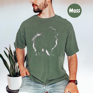 a man with a beard wearing a green t - shirt