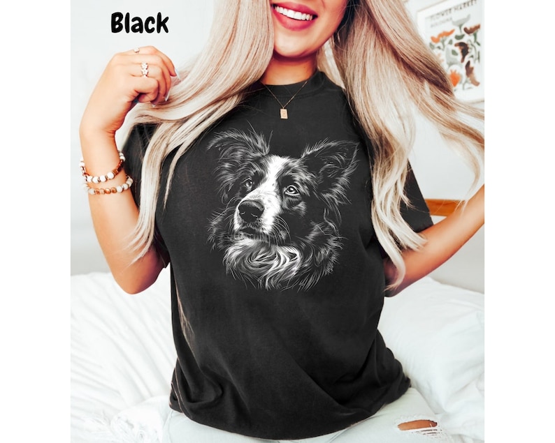 a woman wearing a black shirt with a dog on it