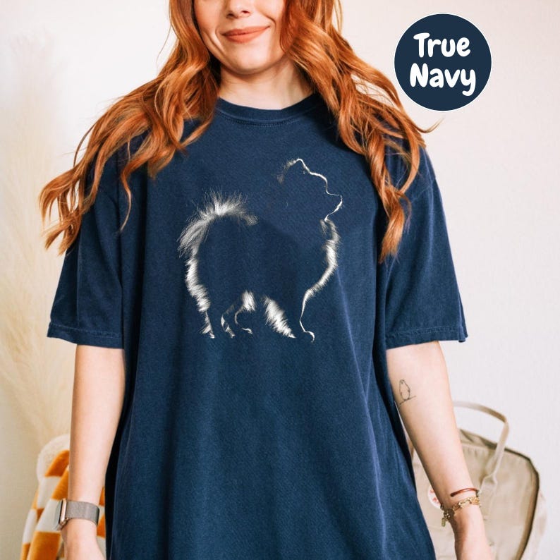 a woman wearing a t - shirt with a picture of a dog on it