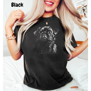 a woman wearing a black shirt with a dog on it