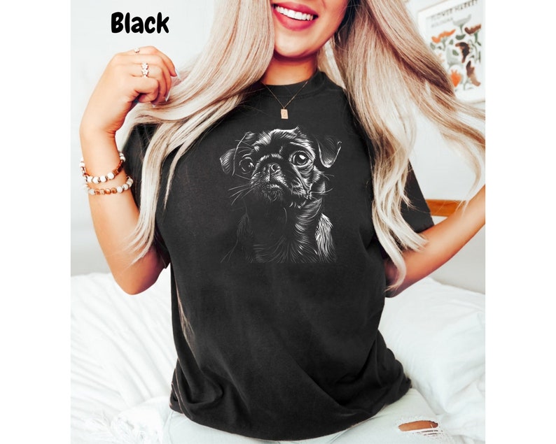 a woman wearing a black shirt with a dog on it