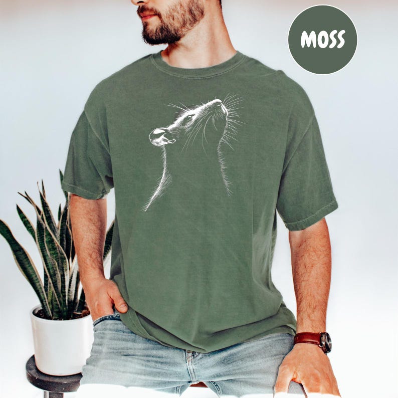 a man wearing a t - shirt with a picture of a rat on it