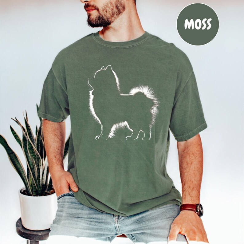 a man wearing a t - shirt with a dog on it