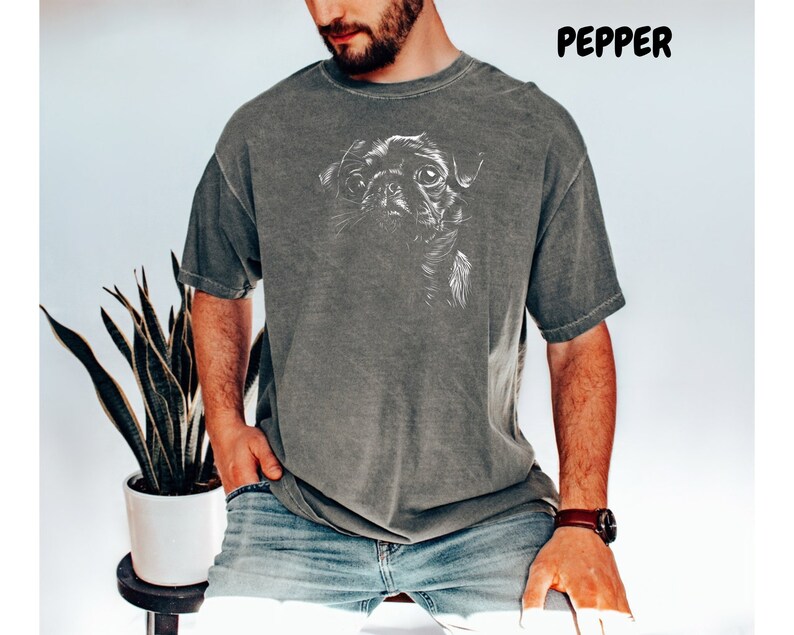 a man wearing a t - shirt with a picture of a dog on it