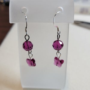 Beautiful, handmade, dangle earrings.  8mm round fuchsia Swarovski crystal with a fuchsia butterfly hanging underneath.