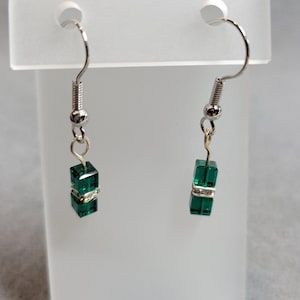 Handmade earrings.  Two green 4mm Swarovski cubes separated w/ a silver and crystal square rondelle.