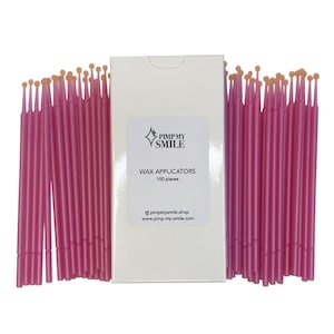 May include: A box of 100 pink disposable wax applicators with a white label that reads "PIMP MY SMILE" and "WAX APPLICATORS 100 pieces" @pimpmysmile.shop www.pimp-my-smile.com