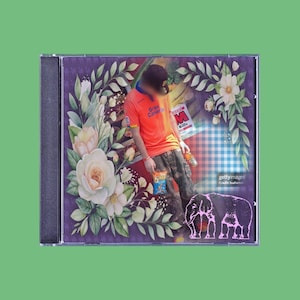 May include: A CD case with a collage design. The design features a person in an orange shirt, floral elements, and an elephant illustration. The text "Gran Canaria" is visible on the shirt. The background is a mix of purple and floral patterns.