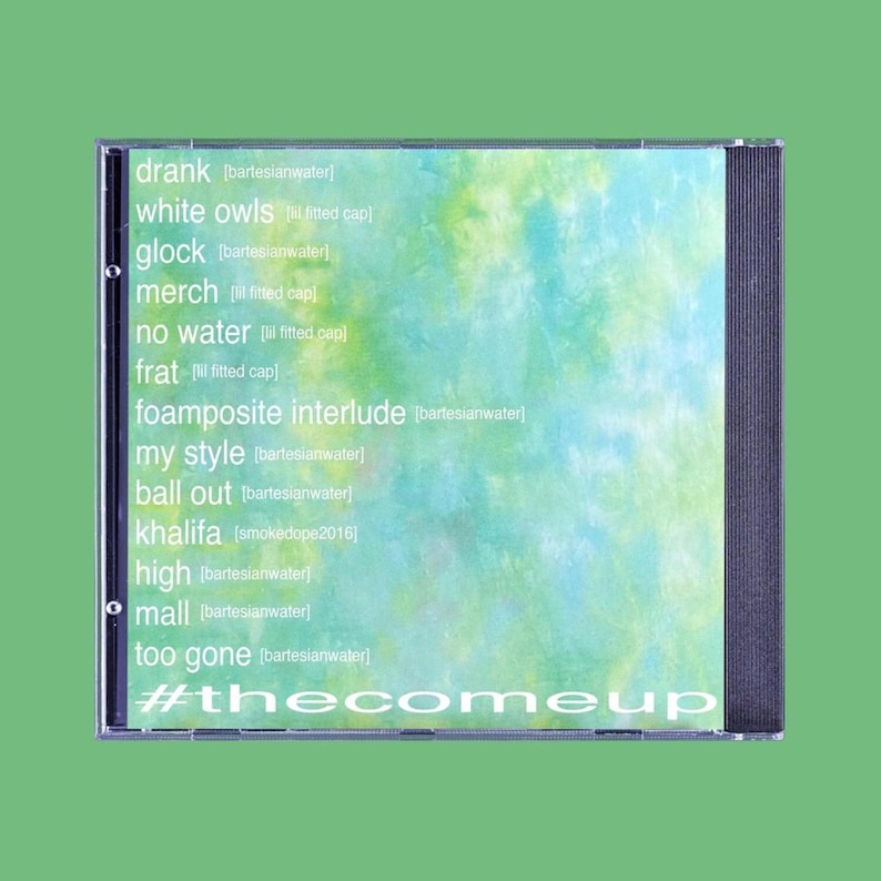 May include: A CD case with a green and blue tie-dye design. The tracklist includes titles like "drank," "white owls," and "#thecomeup." The case is set against a solid green background.