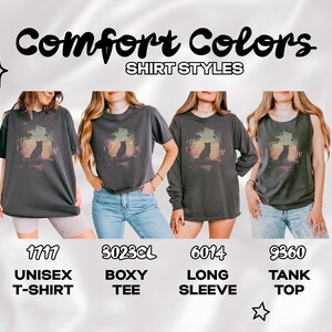 May include: Four dark grey t-shirts with a nature-themed graphic are displayed. The styles include a unisex t-shirt, a boxy tee, a long sleeve, and a tank top. The image includes the text "Comfort Colors" and "SHIRT STYLES".