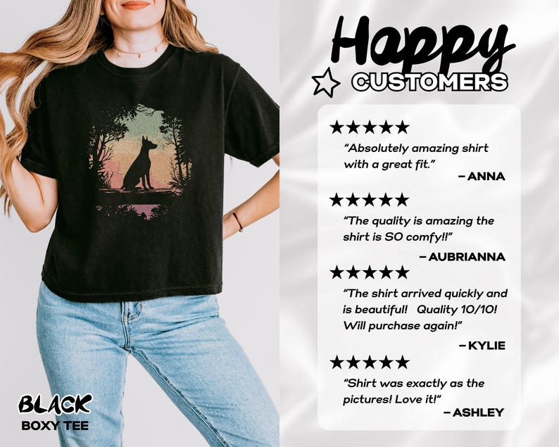 Pu&ograve; includere: T-shirt nero ampio con la silhouette di un cane in una scena di foresta con tonalit&agrave; colorate. La maglietta ha la scritta "BLACK BOXY TEE" in basso. L'immagine include anche recensioni dei clienti.