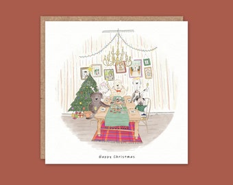 May include: A square Christmas card featuring an illustration of dogs gathered around a table. A Christmas tree and chandelier are visible. The text "Happy Christmas" is at the bottom.