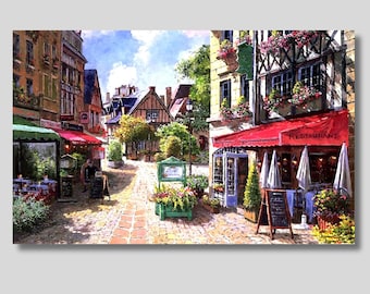 May include: A painting depicting a charming French street scene with cobbled streets, colourful buildings, and a restaurant with a red awning. The restaurant has tables and chairs set up outside, and there are flowers in pots along the street.