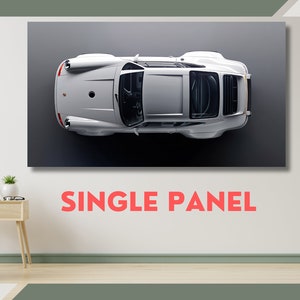 May include: A single panel canvas print featuring a white Porsche 911, viewed from directly above, against a grey background. The text "SINGLE PANEL" is printed below the image.