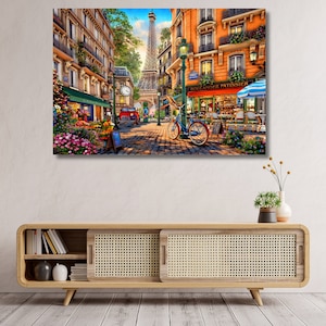May include: A colourful painting depicting a Parisian street scene with a flower shop, a bakery called "Boulanger Patissier", and a person riding a bicycle. The Eiffel Tower can be seen in the distance.