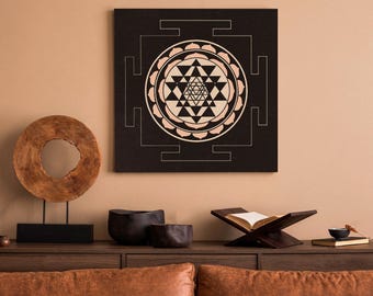 May include: A black and white canvas print with a geometric design. The design is a mandala with a central star shape and a surrounding circle of petals. The mandala is surrounded by a square frame with four smaller squares at each corner.