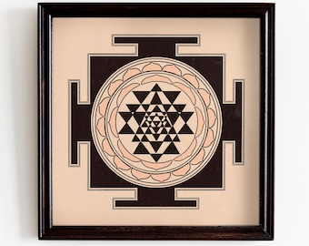May include: A framed print of a black and white Sri Yantra, a sacred geometric symbol in Hinduism, with a peach-colored background.
