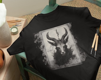 May include: Black t-shirt with a graphic print of a goat's head with horns and a pentagram symbol. The graphic is in a vintage style with a faded background.