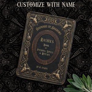 May include: A personalized, dark-colored book titled "Grimoire of Shadows" with the text "Rachel's Book of Potions, Spells & Rituals." The cover features ornate gold-colored embellishments, including ram skulls, bottles, and stars. The words "Customize with Name" are at the top.