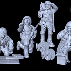 May include: A collection of detailed, gray-toned miniature figurines depicting soldiers in various action poses. One kneels, pointing; another stands with a radio; a third uses binoculars. The figures are likely for a historical diorama or model display.