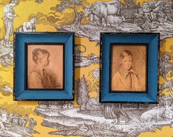 Charming pair of mid-century sepia prints portraits of a boy (“Peter”) and a girl (“Charlotte”) in distressed black and teal blue frames