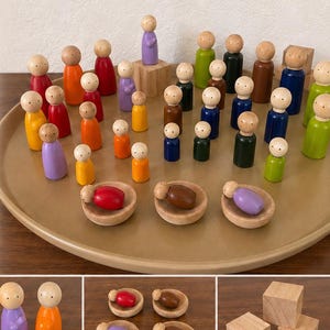 May include: A collection of wooden peg dolls in various solid colors, including red, blue, green, orange, yellow, and purple, arranged on a large circular tray. The set includes small wooden bowls, square blocks, and multiple groupings of figures.