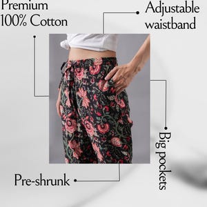 Stylish cotton lounge & sleepwear pants for women with bold red flowers on deep black – soft and comfy pajama bottoms with elastic waist, adjustable drawstring, and practical side pockets, perfect for pajama parties, floral print clothing lovers, or unique handmade jammies that make thoughtful gifts for book lovers or flower fans.