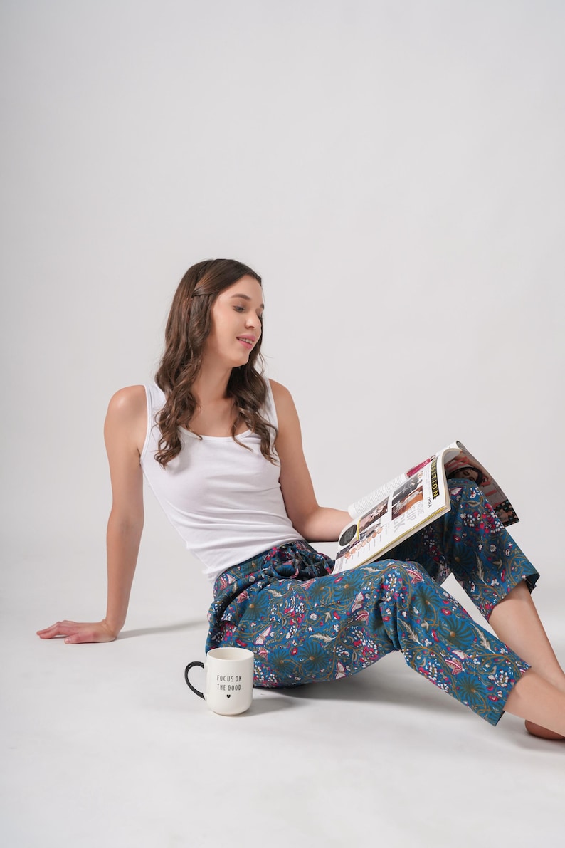 Handmade hippie-style cotton pants for women with elastic waistband, drawstring, and deep pockets; colorful floral and butterfly print ideal for festival wear or meditation.