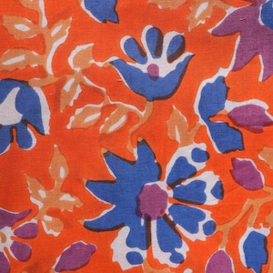 Modern and trendy women’s cotton lounge pants with eye-catching blue and purple floral patterns on a warm orange background – lightweight, soft jammies featuring elastic waistband, adjustable drawstring, and roomy pockets, great for casual lounging, pajama parties, and thoughtful 2nd anniversary gifts or cotton gift ideas for nature enthusiasts.
