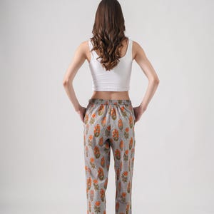 Boho-inspired floral print lounge pants featuring soft gray cotton with bright orange flowers – handmade sleep trousers with elastic waist, drawstring closure, and pockets, ideal as stylish pj pants for reading, relaxing, or giving as gifts for book lovers, flower lovers, or self-care enthusiasts.