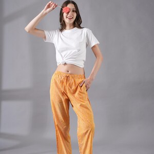 Lightweight 100% cotton pj pants with striking red and yellow stripes – relaxed fit sleepwear with elastic waistband, drawstring, and deep side pockets, perfect for book lovers, traveler gifts, or as modern sleep pajamas that feel soft, comfy, and cooling for warm weather lounging.