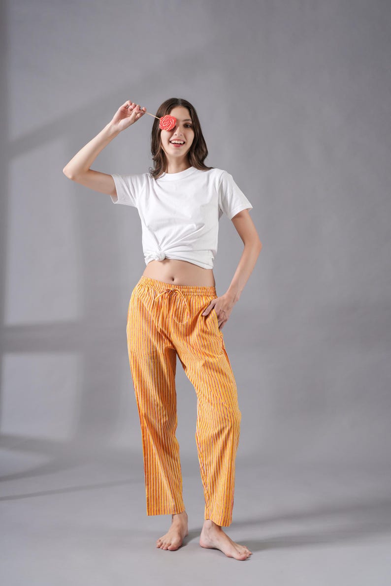 Lightweight 100% cotton pj pants with striking red and yellow stripes – relaxed fit sleepwear with elastic waistband, drawstring, and deep side pockets, perfect for book lovers, traveler gifts, or as modern sleep pajamas that feel soft, comfy, and cooling for warm weather lounging.