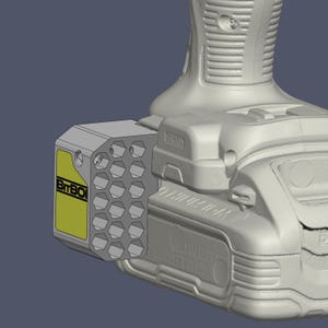 May include: A light grey BitBOI drill bit holder attachment featuring a honeycomb pattern of hexagonal storage slots and a yellow rectangular label with black text, mounted to the side of a DeWalt power tool battery pack.